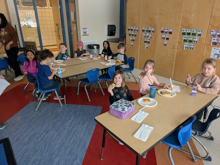 Students eating pancakes in their classroom